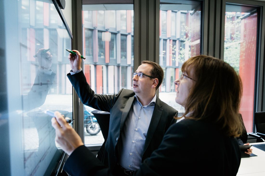 Colleagues brainstorming together on a SMART interactive display