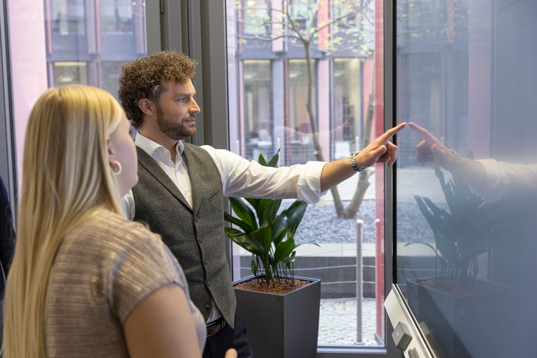 Two colleagues collaborating by touch on a SMART Board