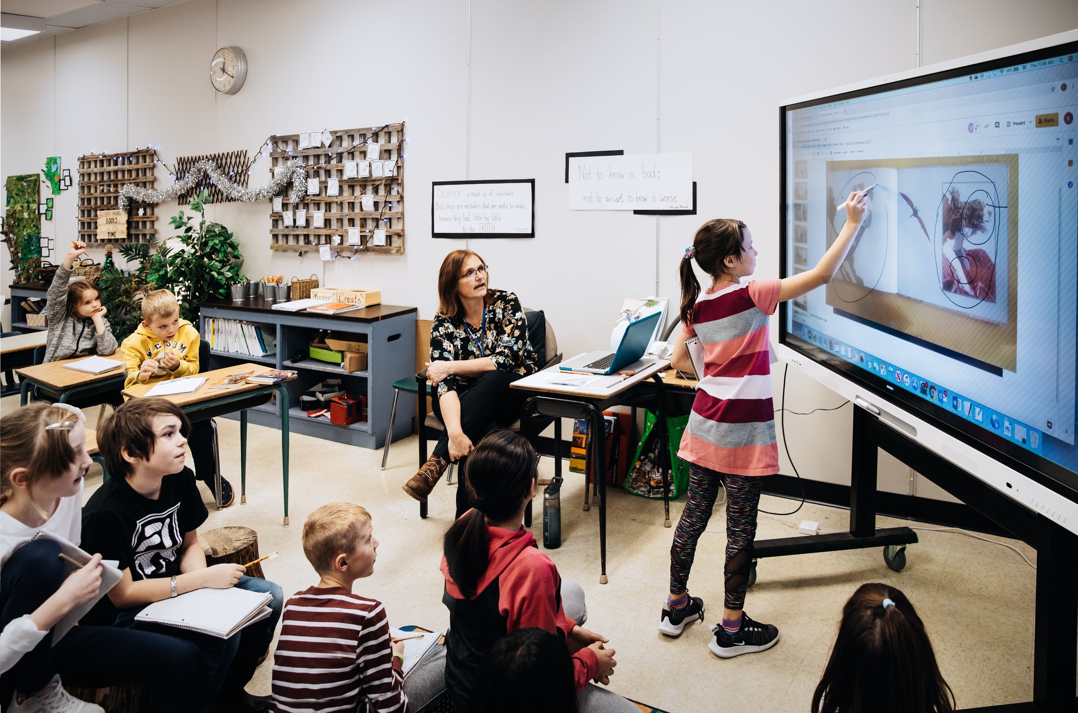 Students engaged at a Technetix SMART interactive display in a modern classroom